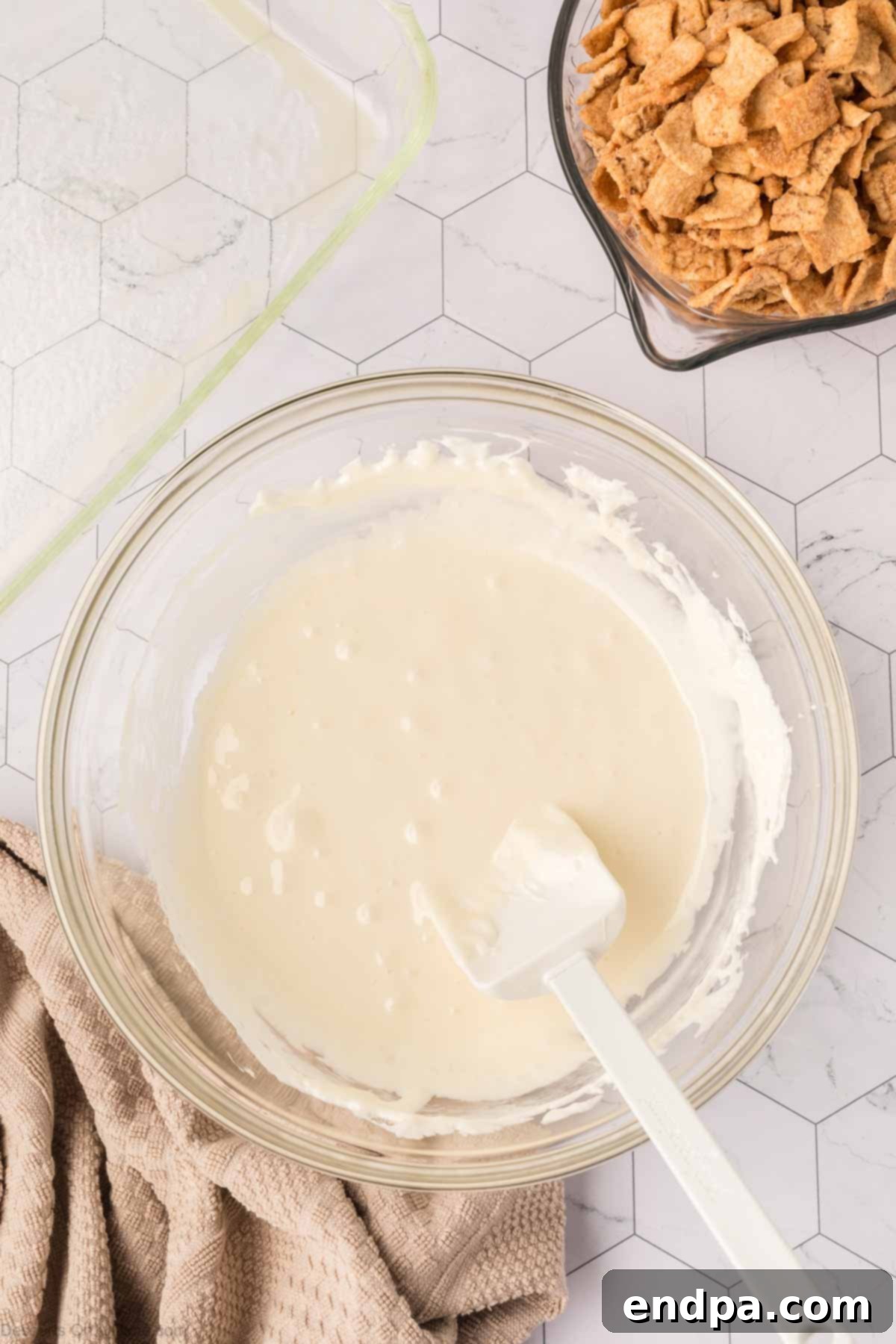 Marshmallow and butter mixture perfectly melted and smooth in a bowl, ready for the cereal.