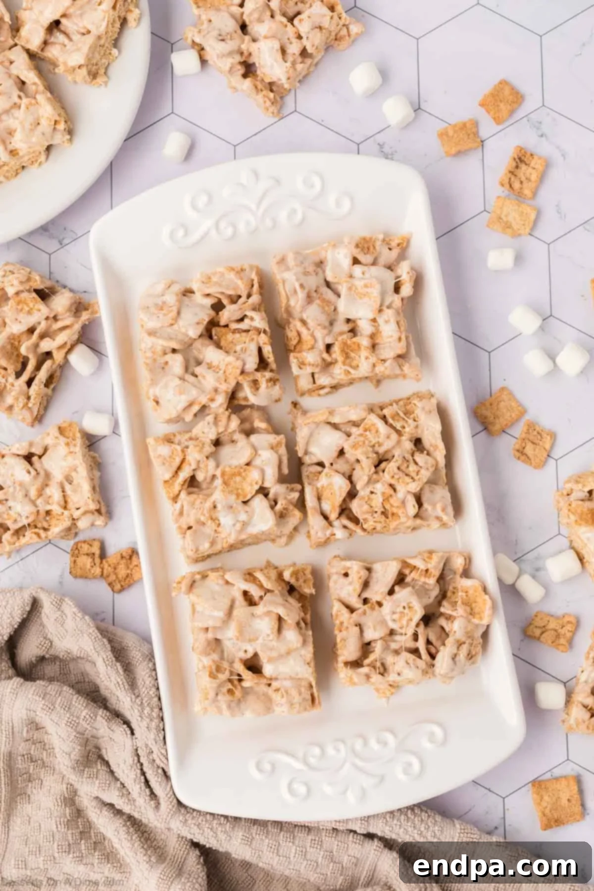 Cinnamon Toast Crunch Cereal Bars neatly cut into perfect squares within the baking pan.