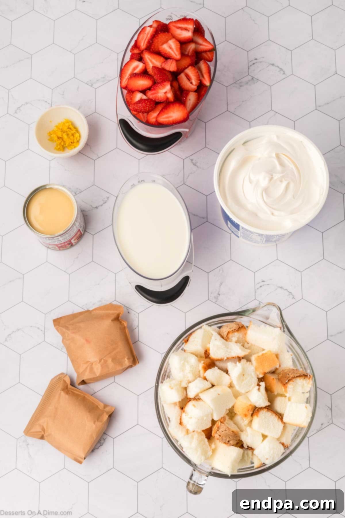 Ingredients for Lemon Trifle including angel food cake, lemon pudding mixes, cold milk, sweetened condensed milk, whipped topping, fresh strawberries, and lemon zest.