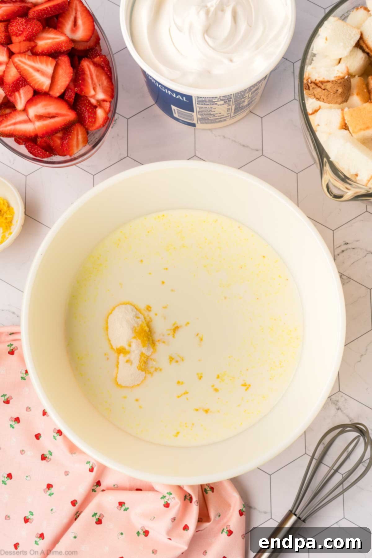 Pudding mixture with lemon zest combined smoothly in a mixing bowl.