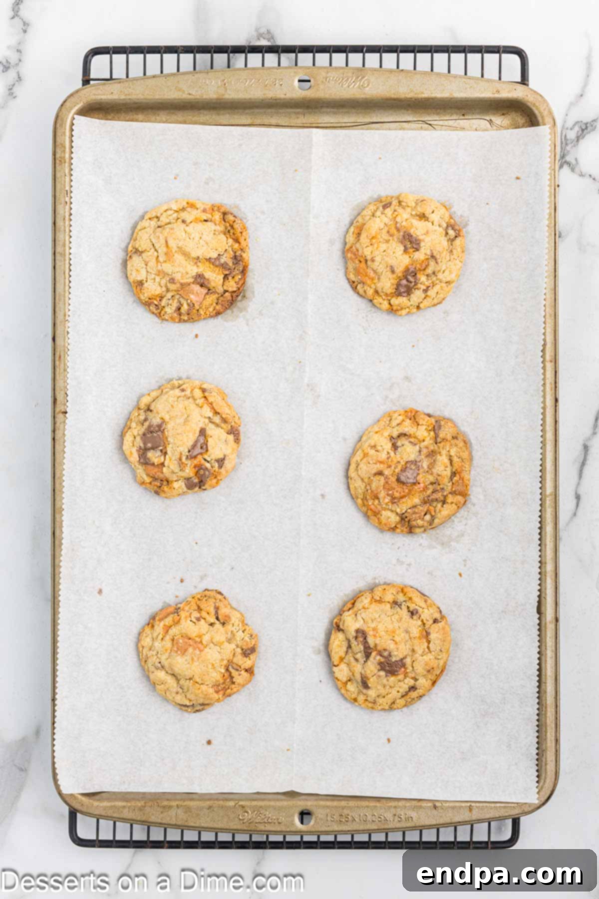 Butterfinger cookies on baking sheet cooling.