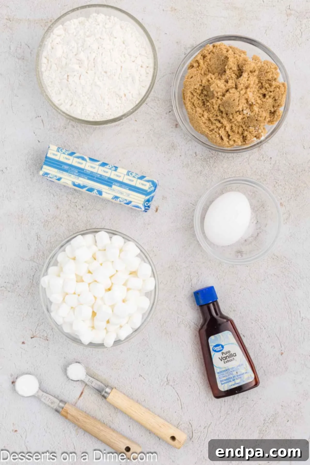Fluffy Cloud Cookies 3 Ingredients for Marshmallow Cookies: flour, baking soda, butter, brown sugar, vanilla, eggs, and mini marshmallows laid out on a surface.
