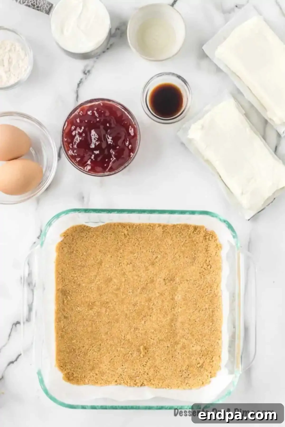 Decadent Raspberry Cheesecake Bars 5 Crumbs in baking dish.