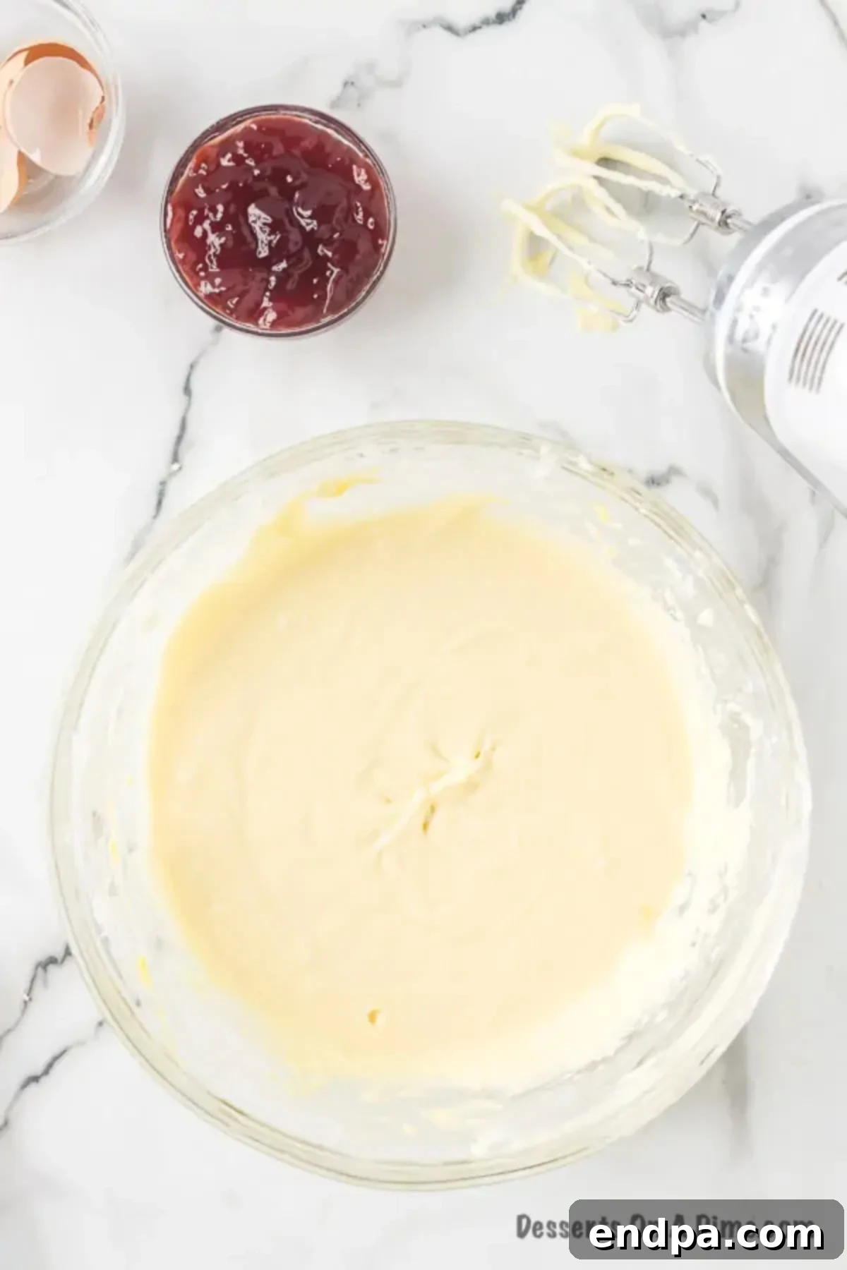 Decadent Raspberry Cheesecake Bars 8 Mixture combined in a bowl.