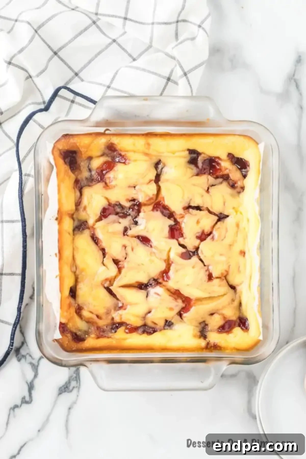 Decadent Raspberry Cheesecake Bars 10 Raspberry Bars in baking dish cooling.