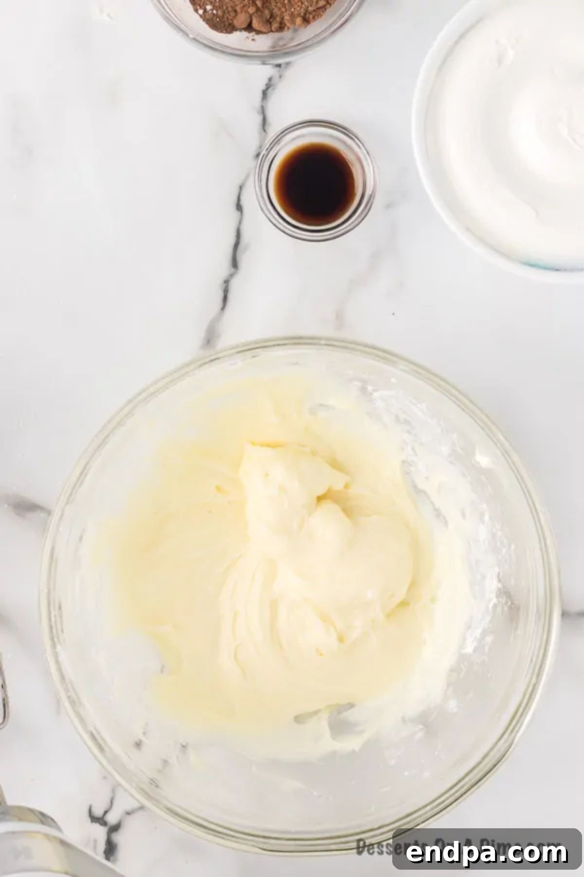 Sweet Chocolate Fruit Indulgence 4 Cream cheese and powdered sugar being mixed together in a bowl.