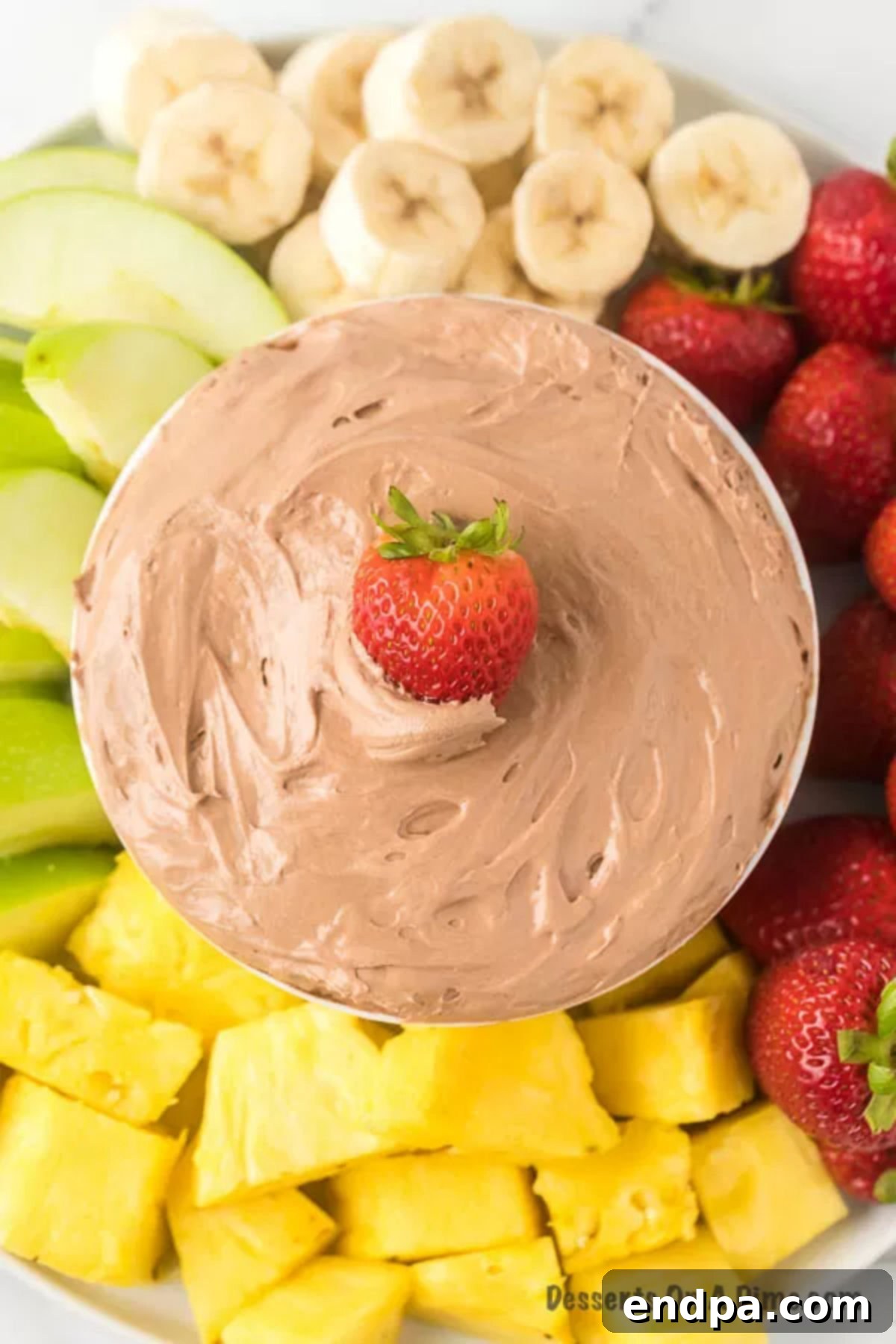 Sweet Chocolate Fruit Indulgence 8 Close-up of the chocolate fruit dip in a bowl, surrounded by a colorful assortment of fresh fruit.
