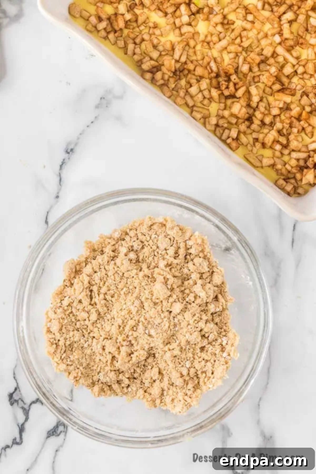 A mixing bowl showing brown sugar, flour, quick cooking oats, and softened butter combined to form a crumbly streusel topping.