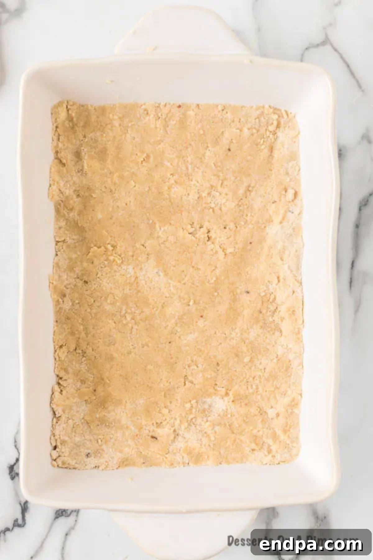 The shortbread crust mixture pressed evenly into the bottom of a 9x13 inch baking pan.