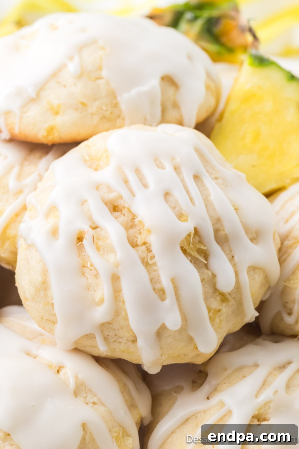 Stacked Pineapple Cookies with a luscious glaze, showcasing their soft texture and golden-brown edges. Perfect for a tropical dessert.