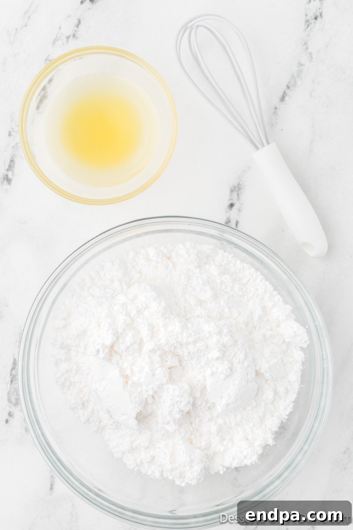 Powdered sugar and pineapple juice, the only two ingredients for the glaze, are measured out and ready to be combined.