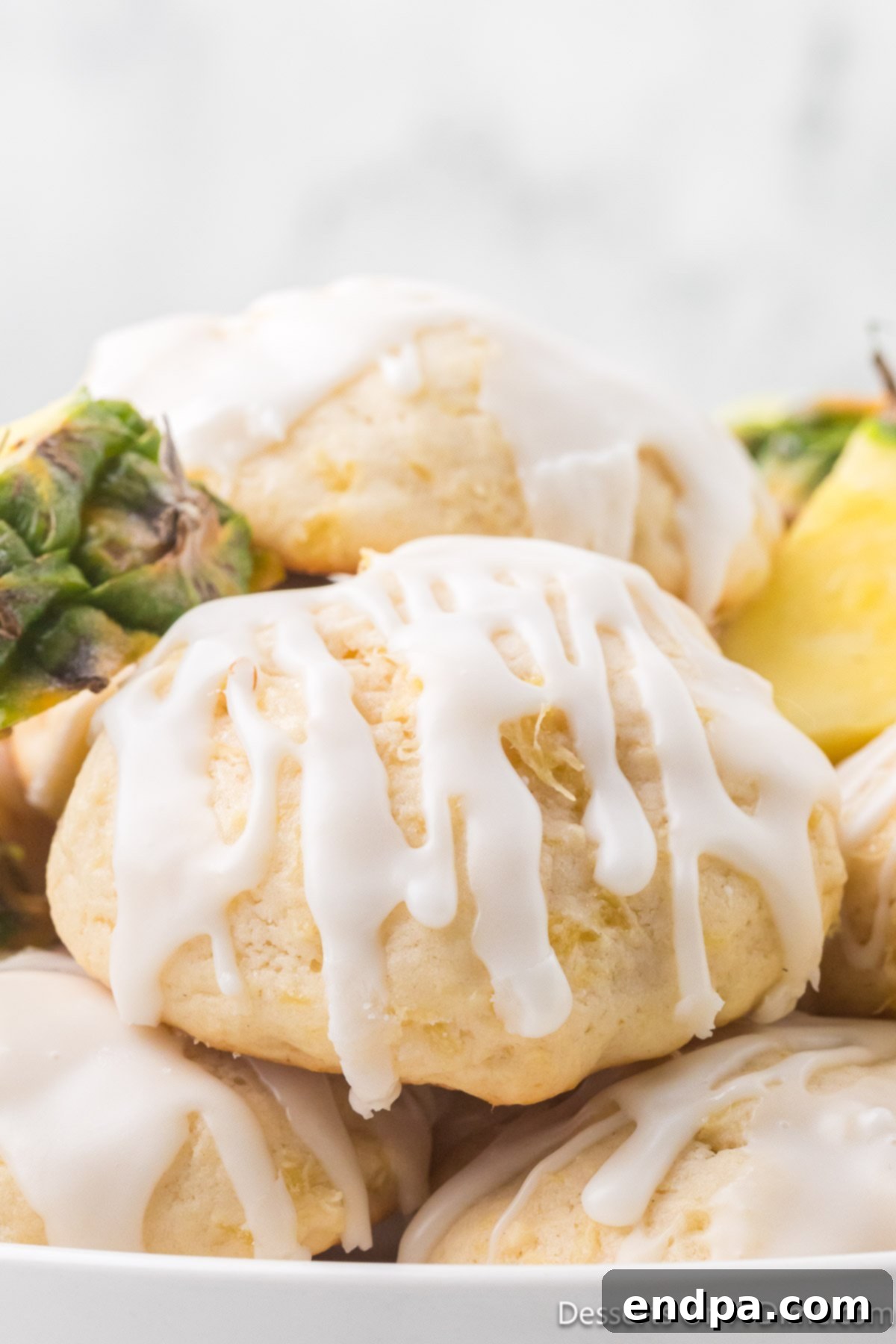 Pineapple Cookies perfectly stacked together on a serving plate, beautifully glazed and ready to be enjoyed.