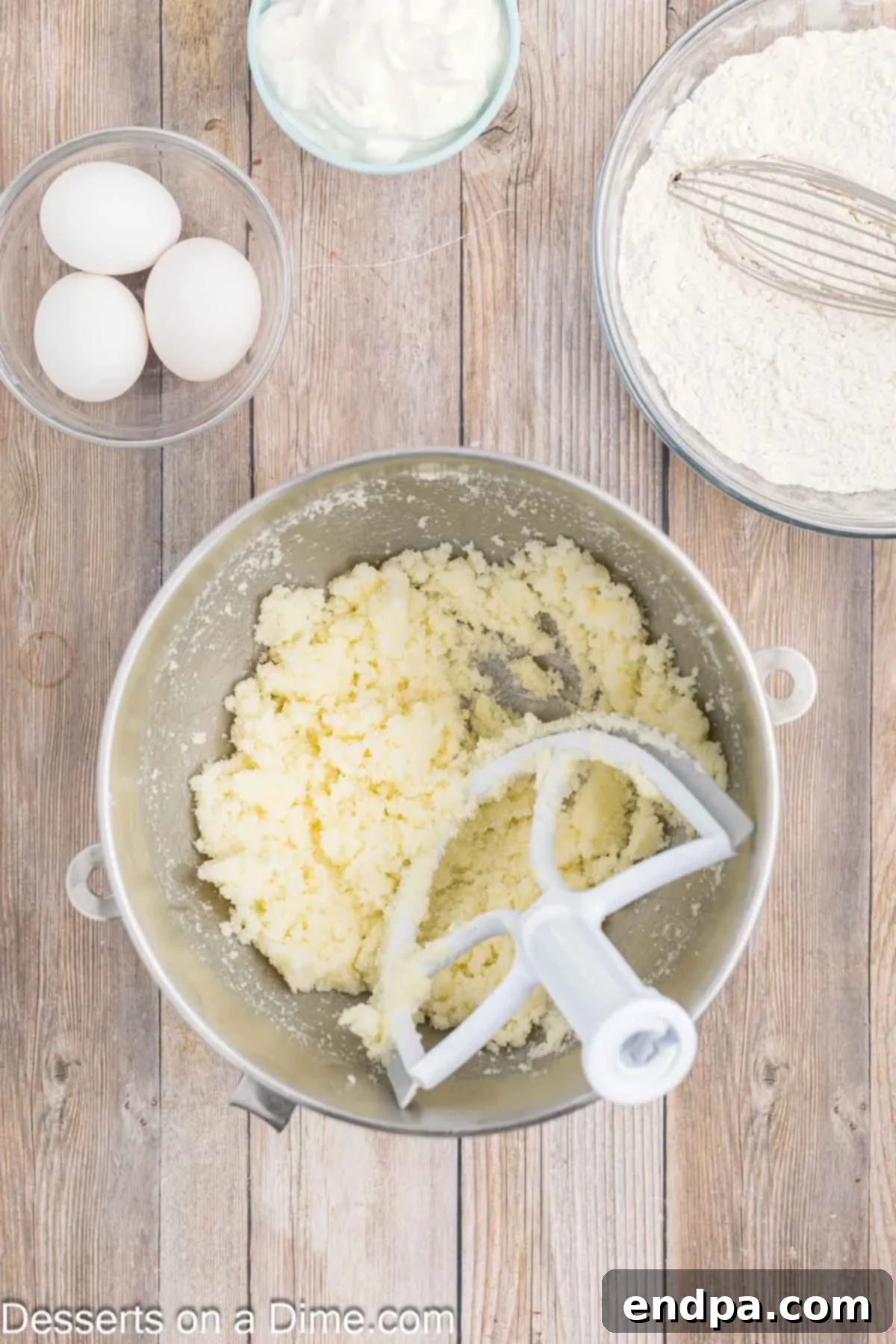 Sapphire Swirl Cake 4 Softened butter being creamed with granulated sugar in a stand mixer.