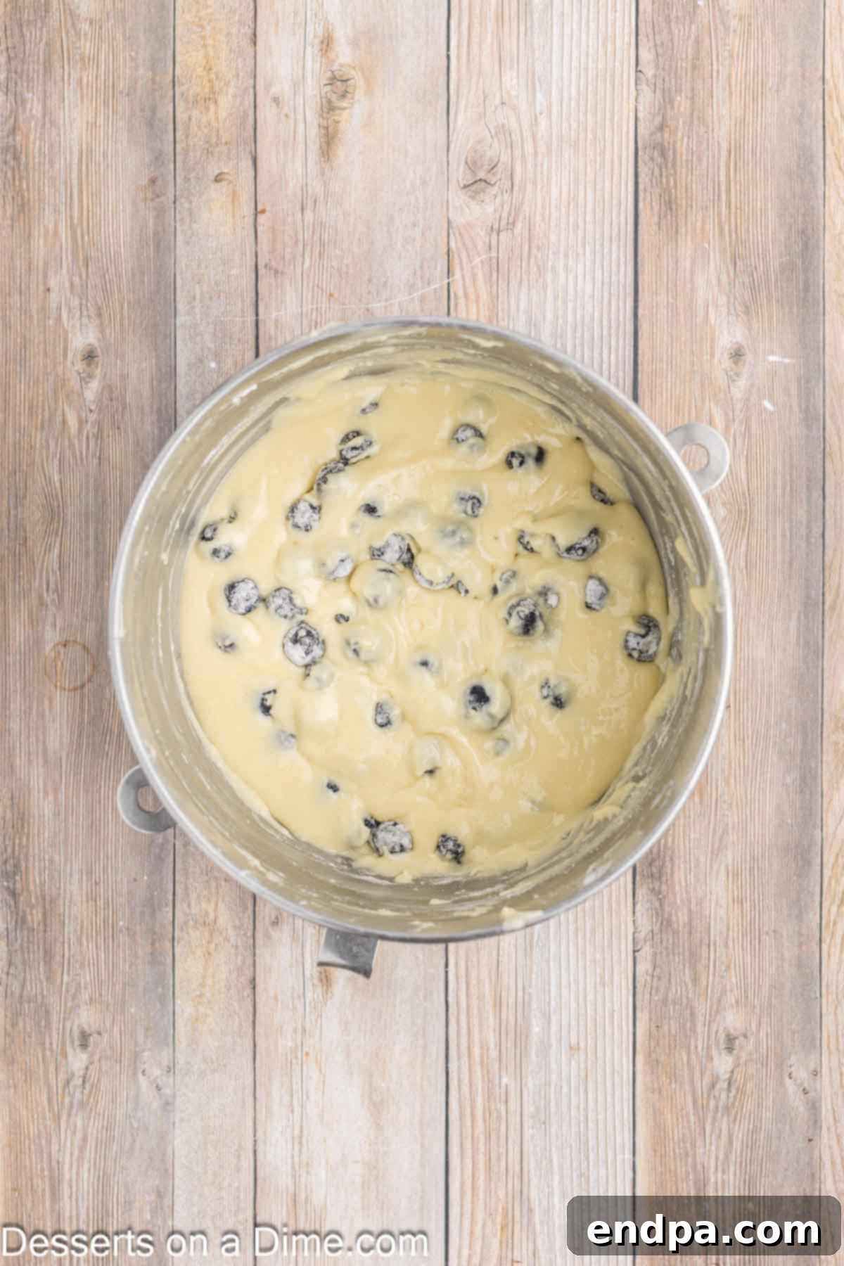 Sapphire Swirl Cake 6 Fresh blueberries coated in flour, ready to be folded into cake batter.