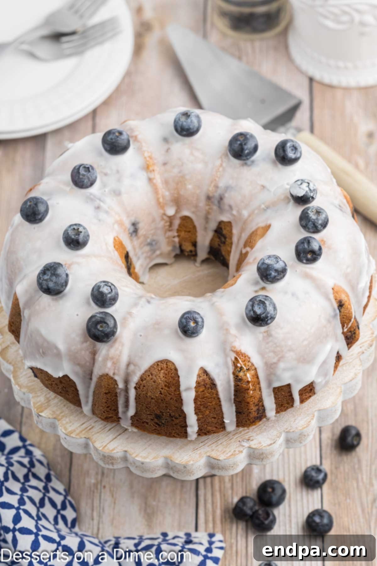 Sapphire Swirl Cake 8 A whole Blueberry Bundt Cake, perfectly glazed and ready to be sliced for serving.