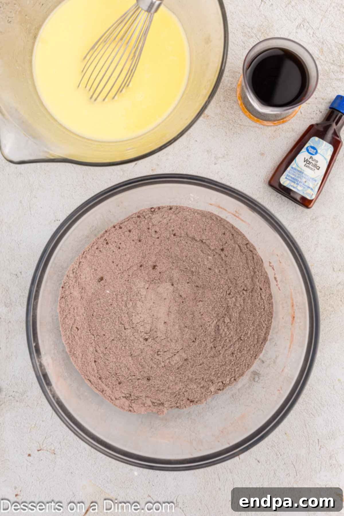 Ultimate Dark Chocolate Decadence 4 Dry ingredients for the blackout cake are combined in a large mixing bowl, ready for the wet ingredients.