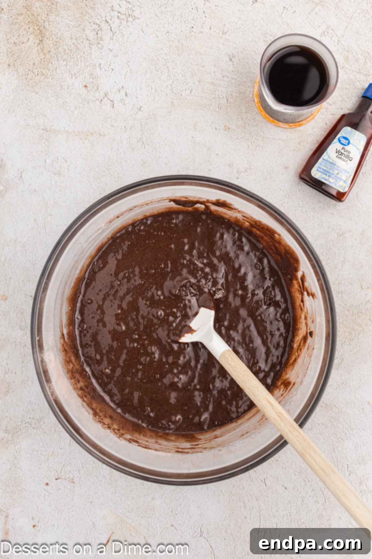 Ultimate Dark Chocolate Decadence 5 Wet and dry ingredients for the blackout cake are perfectly mixed together in a bowl, creating a smooth, dark batter.