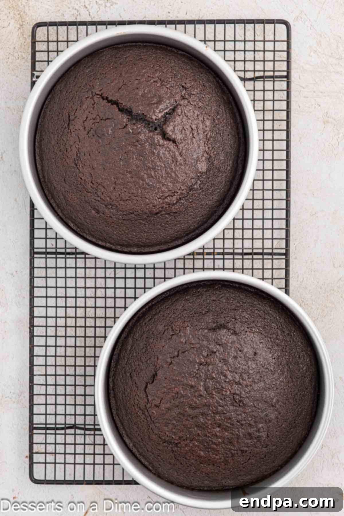 Ultimate Dark Chocolate Decadence 7 Freshly baked blackout cakes cooling on a wire rack after being removed from their pans.