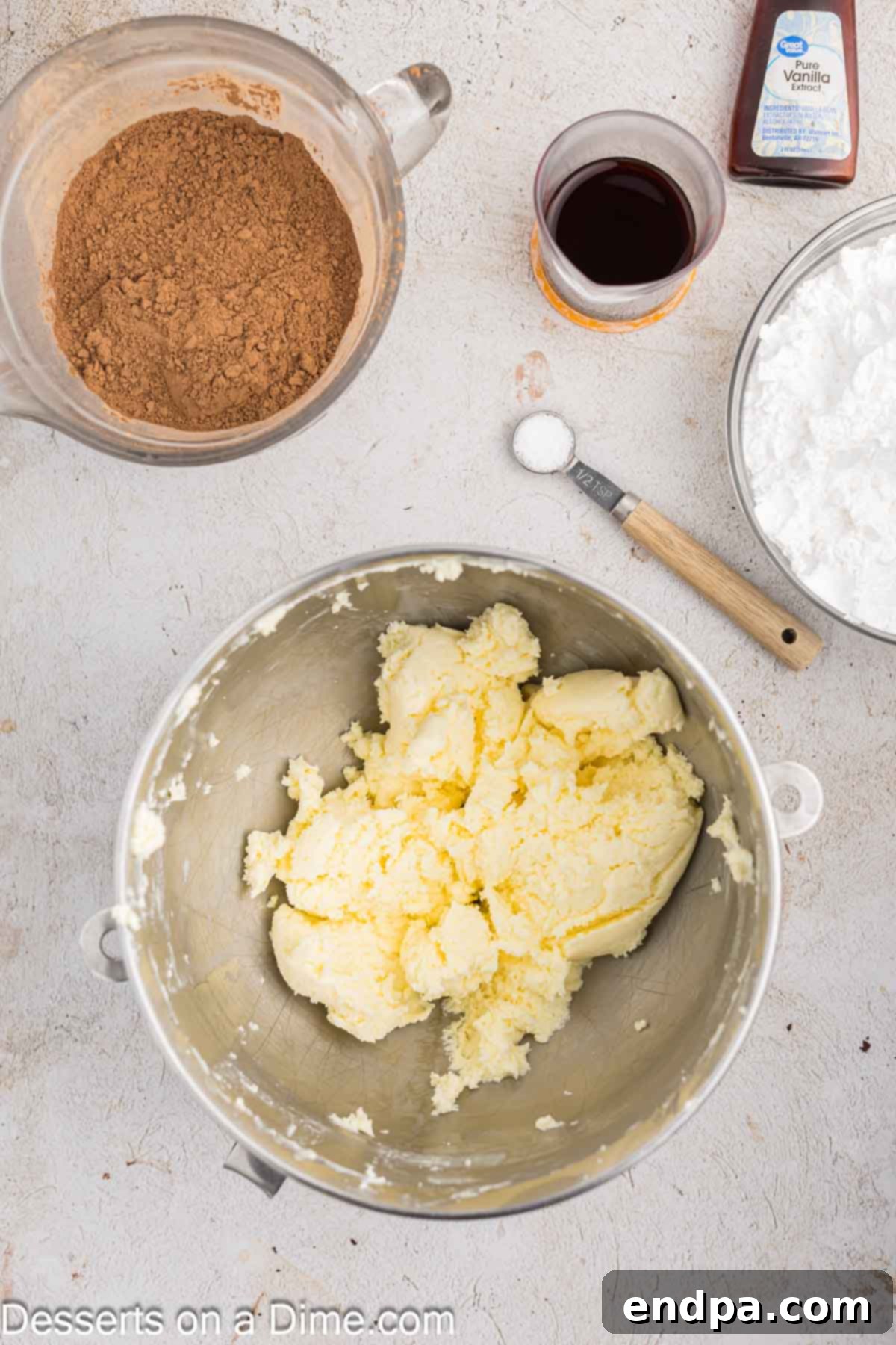 Ultimate Dark Chocolate Decadence 8 Softened butter being beaten until light and fluffy in a stand mixer bowl, forming the base of the frosting.