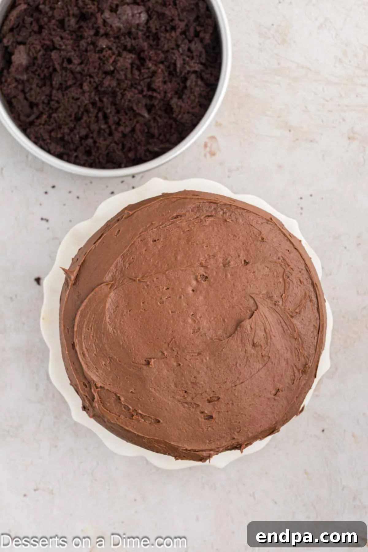 Ultimate Dark Chocolate Decadence 10 A multi-layered Blackout Cake, generously topped with rich chocolate frosting and awaiting its signature crumb coating.