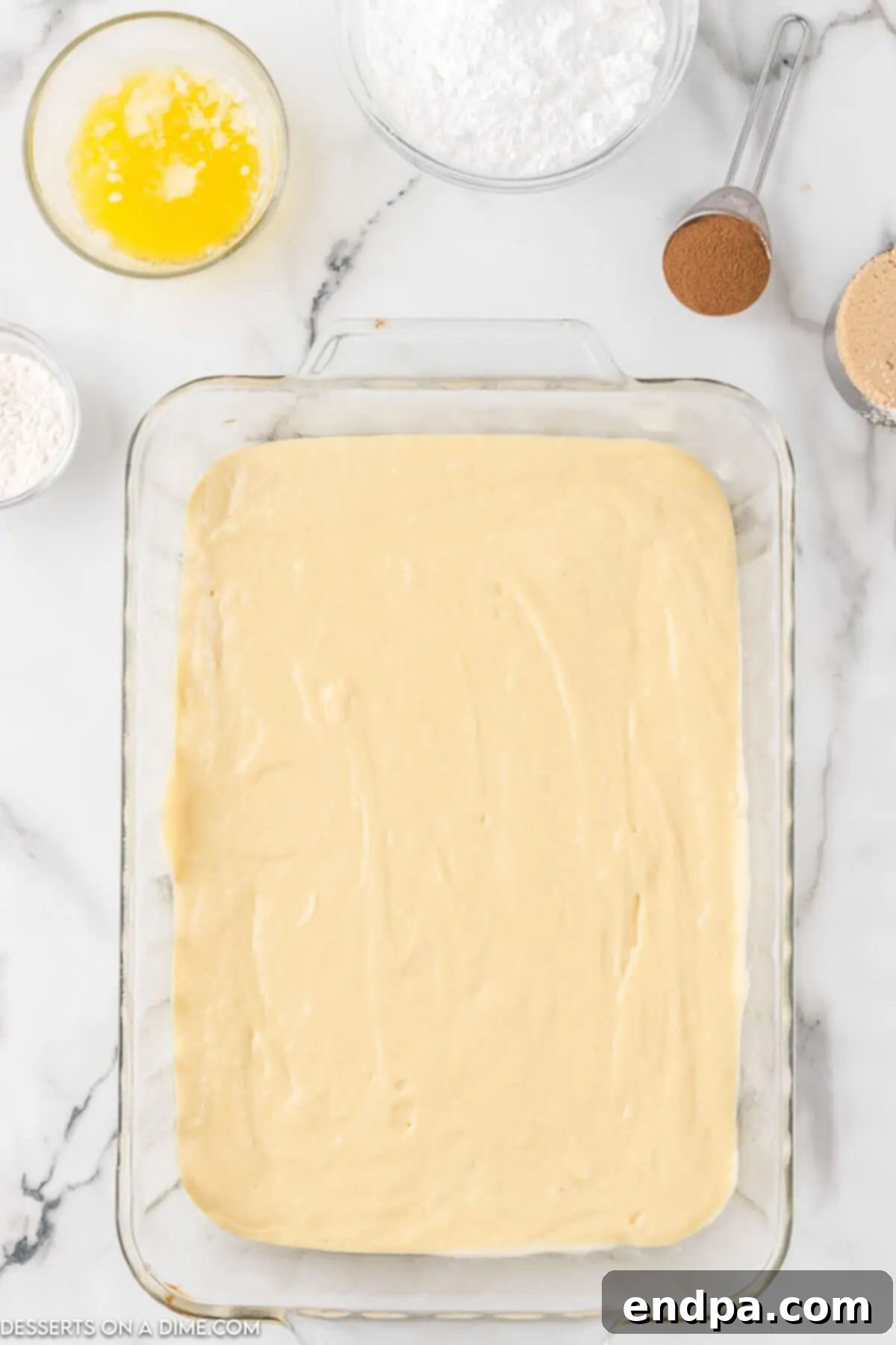 Indulgent Cinnamon Roll Cake Delight 4 Pouring the cake batter in a baking dish