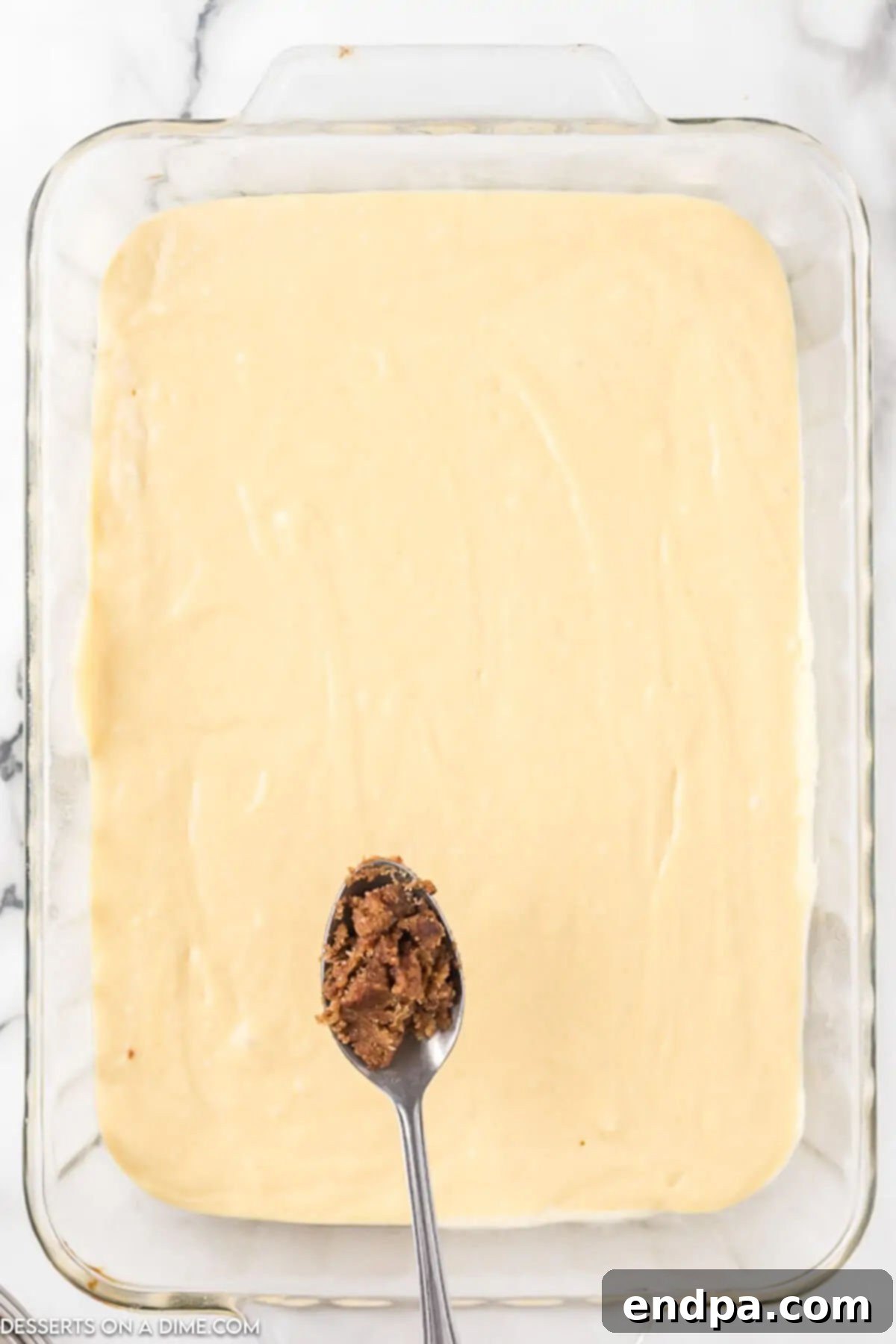 Indulgent Cinnamon Roll Cake Delight 6 Scooping the cinnamon mixture with a spoon