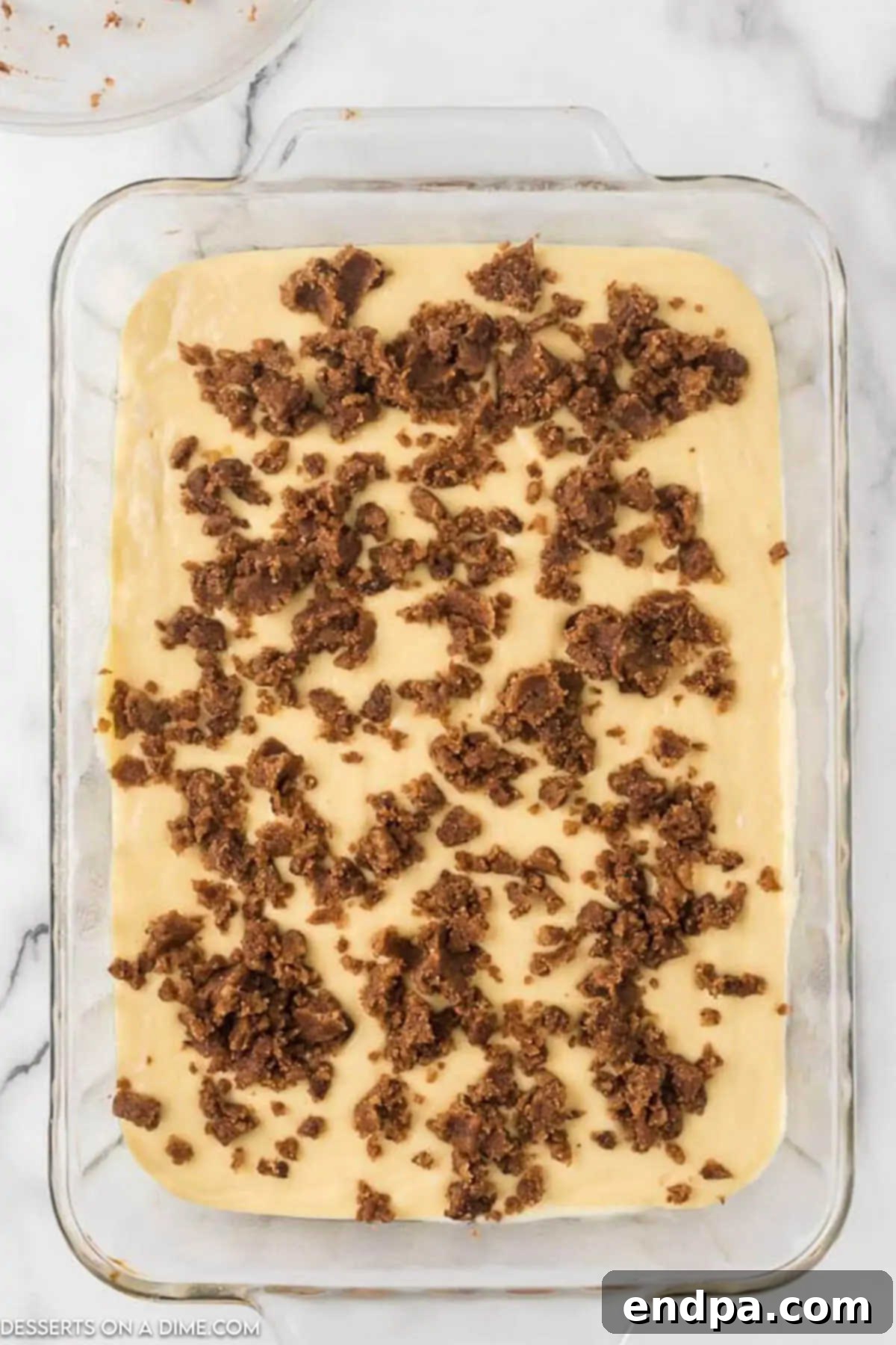 Indulgent Cinnamon Roll Cake Delight 7 Dropping the cinnamon mixture on the cake