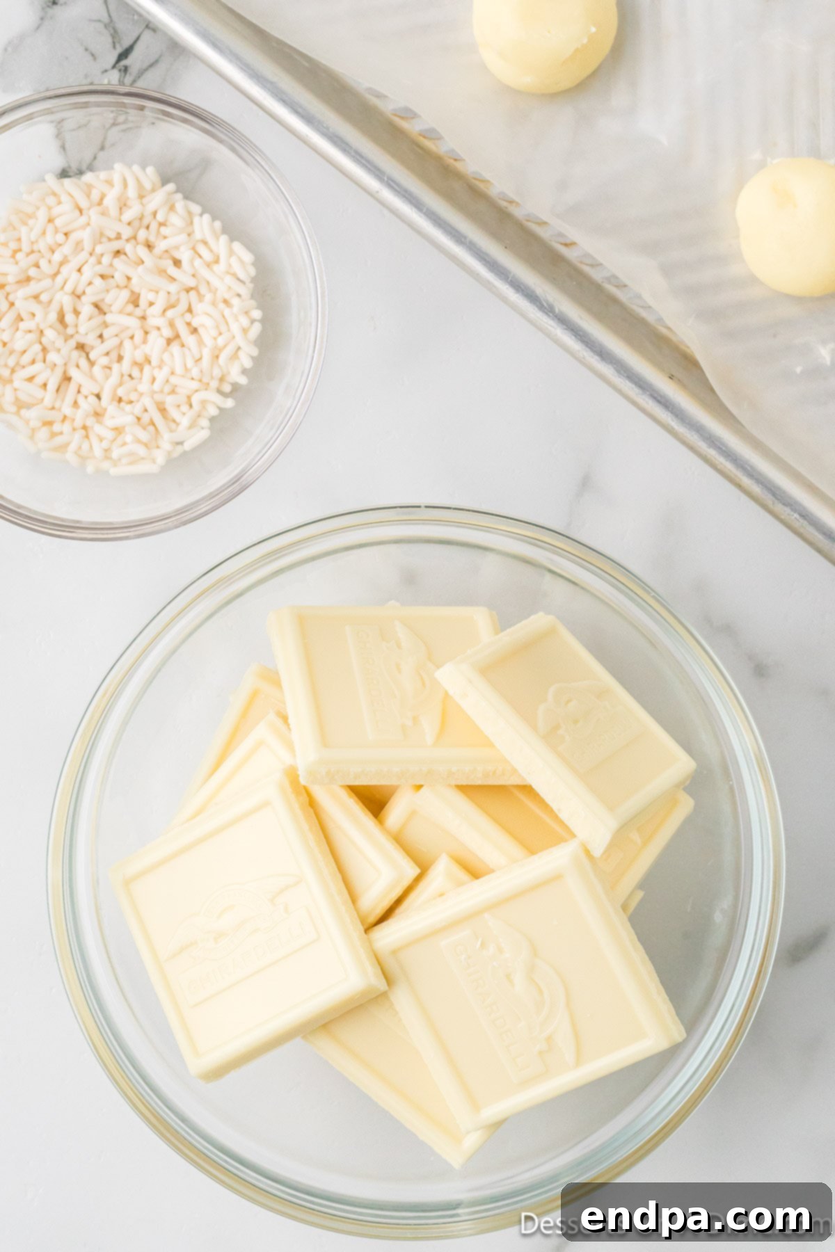 Remaining white chocolate baking bars in a microwave-safe bowl, ready for melting.