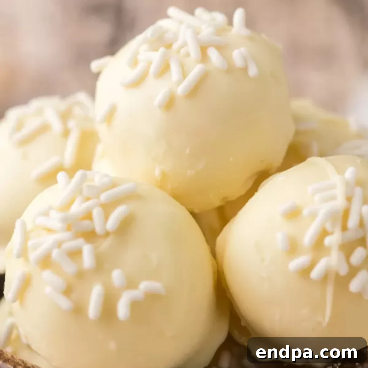 A beautifully composed image of white chocolate truffles, showcasing their delicate texture and sprinkles, ready to be enjoyed.