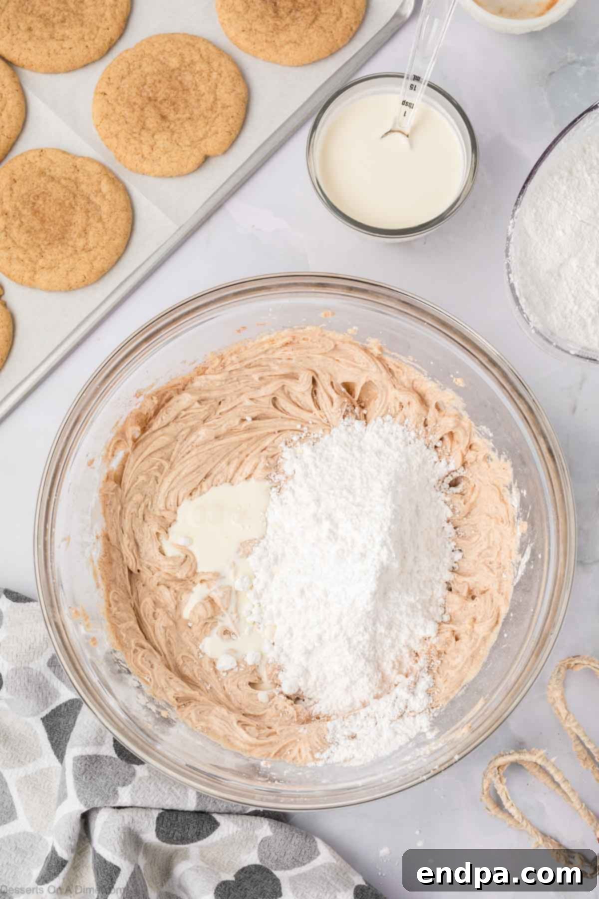 Spanish Cinnamon Sugar Cookies 14 Frosting mixture with powdered sugar in a bowl.