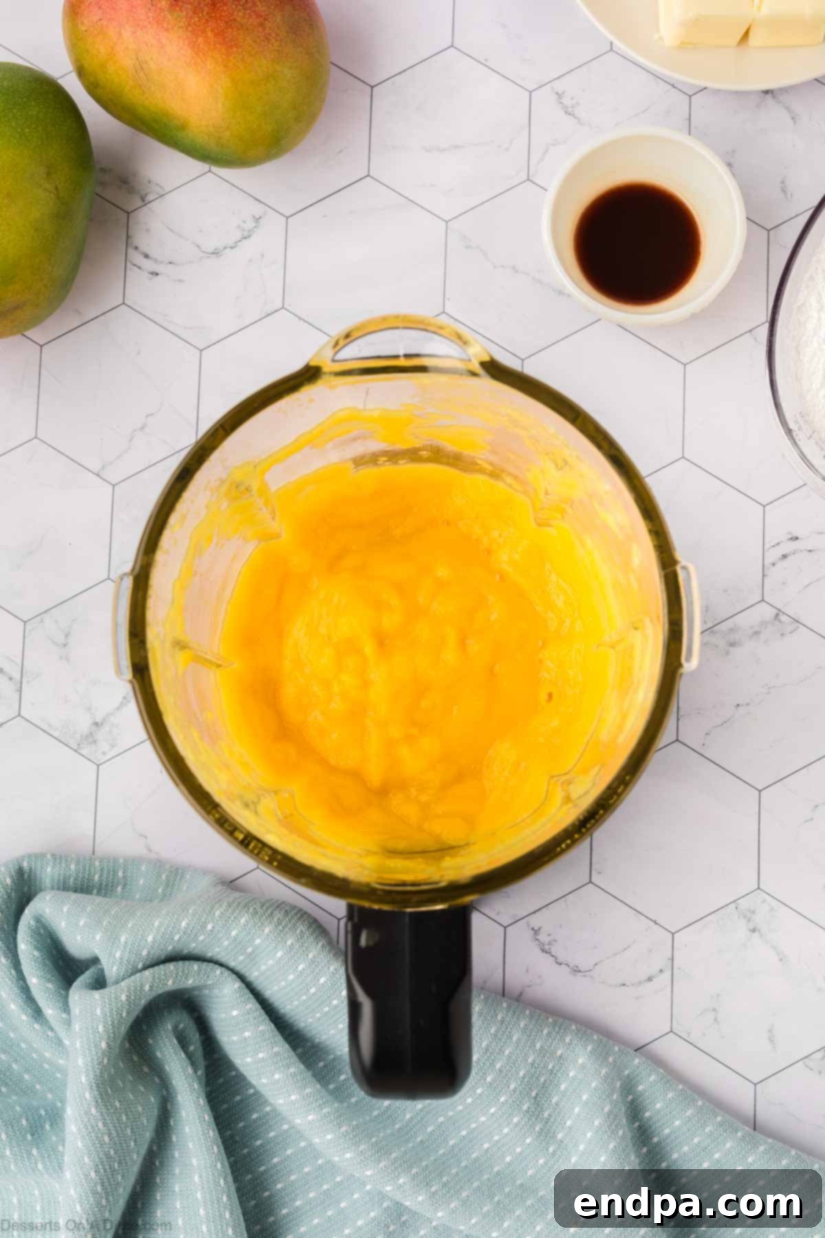 Smooth mango puree in a blender, with sugar added according to taste, ready for the cake filling.