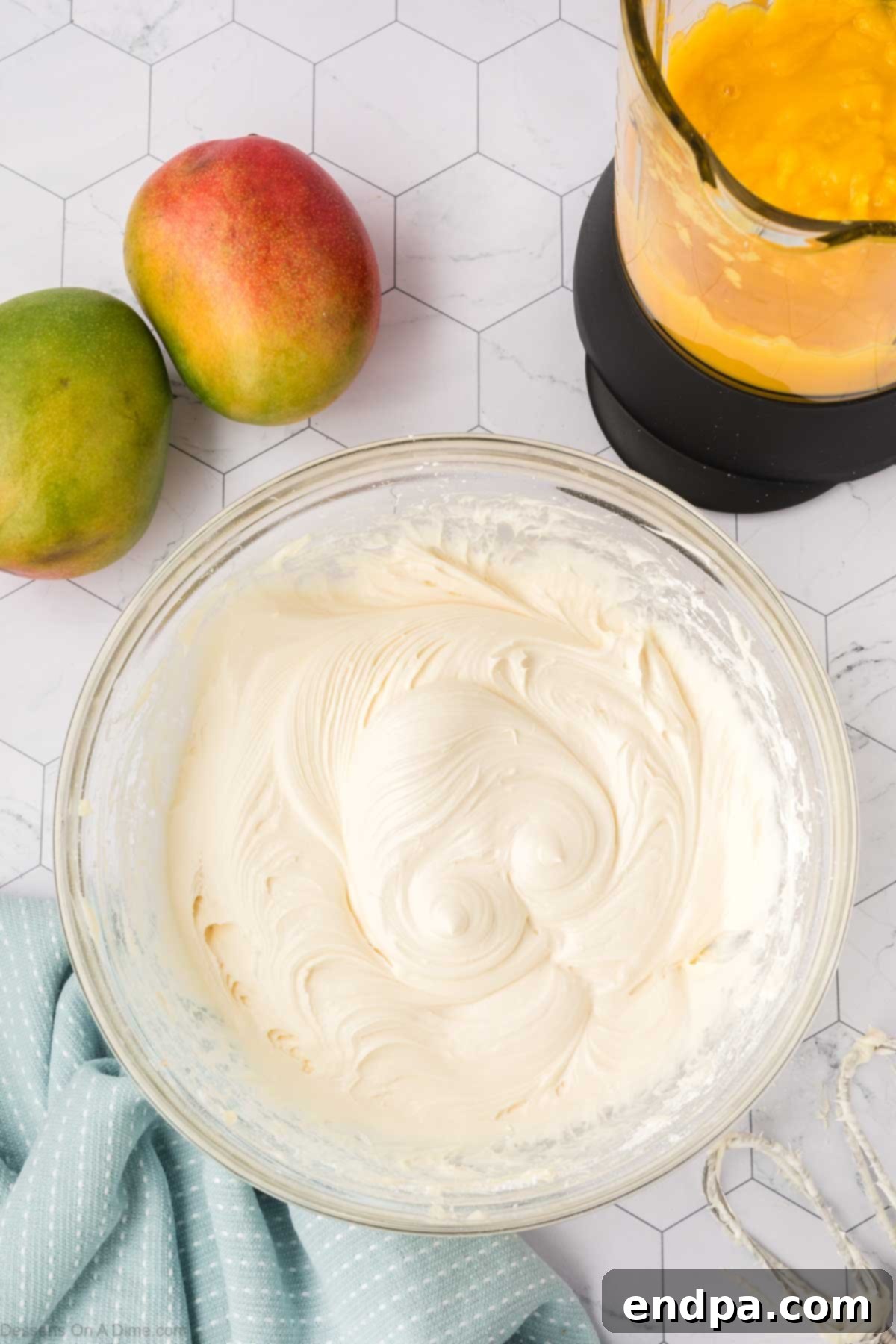 Cream cheese frosting fully combined and whipped to a light and fluffy consistency in a mixing bowl.