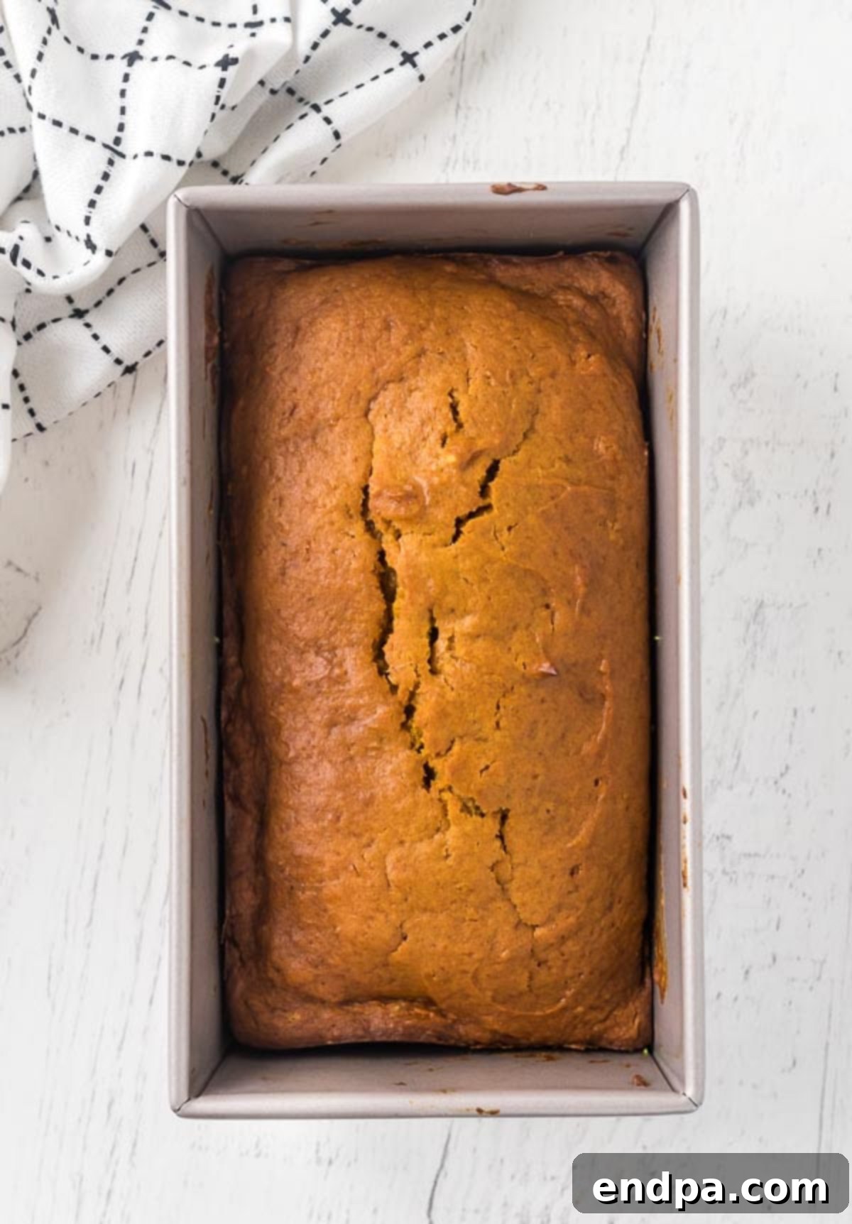 The pumpkin bread fully baked in a loaf pan.