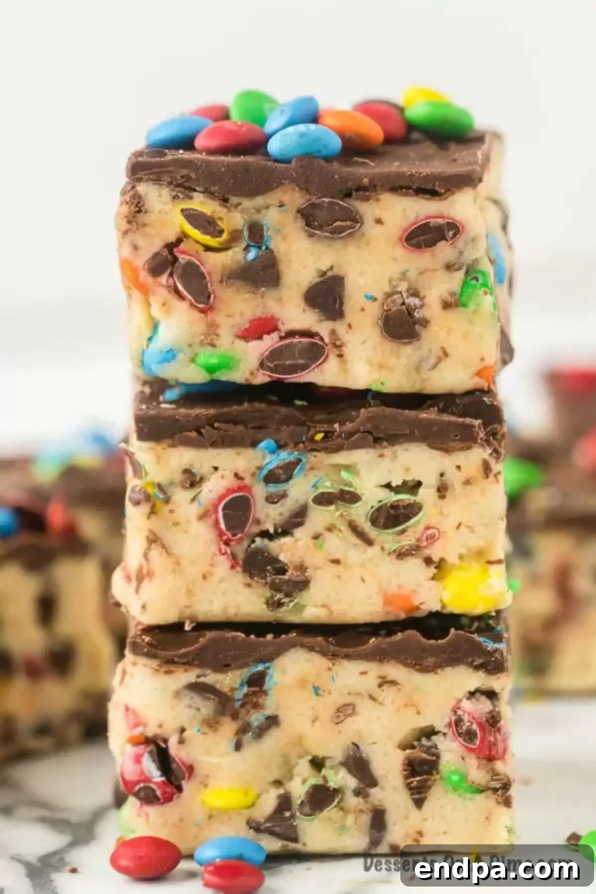 Vanilla extract being added to creamed butter and brown sugar in a mixing bowl.