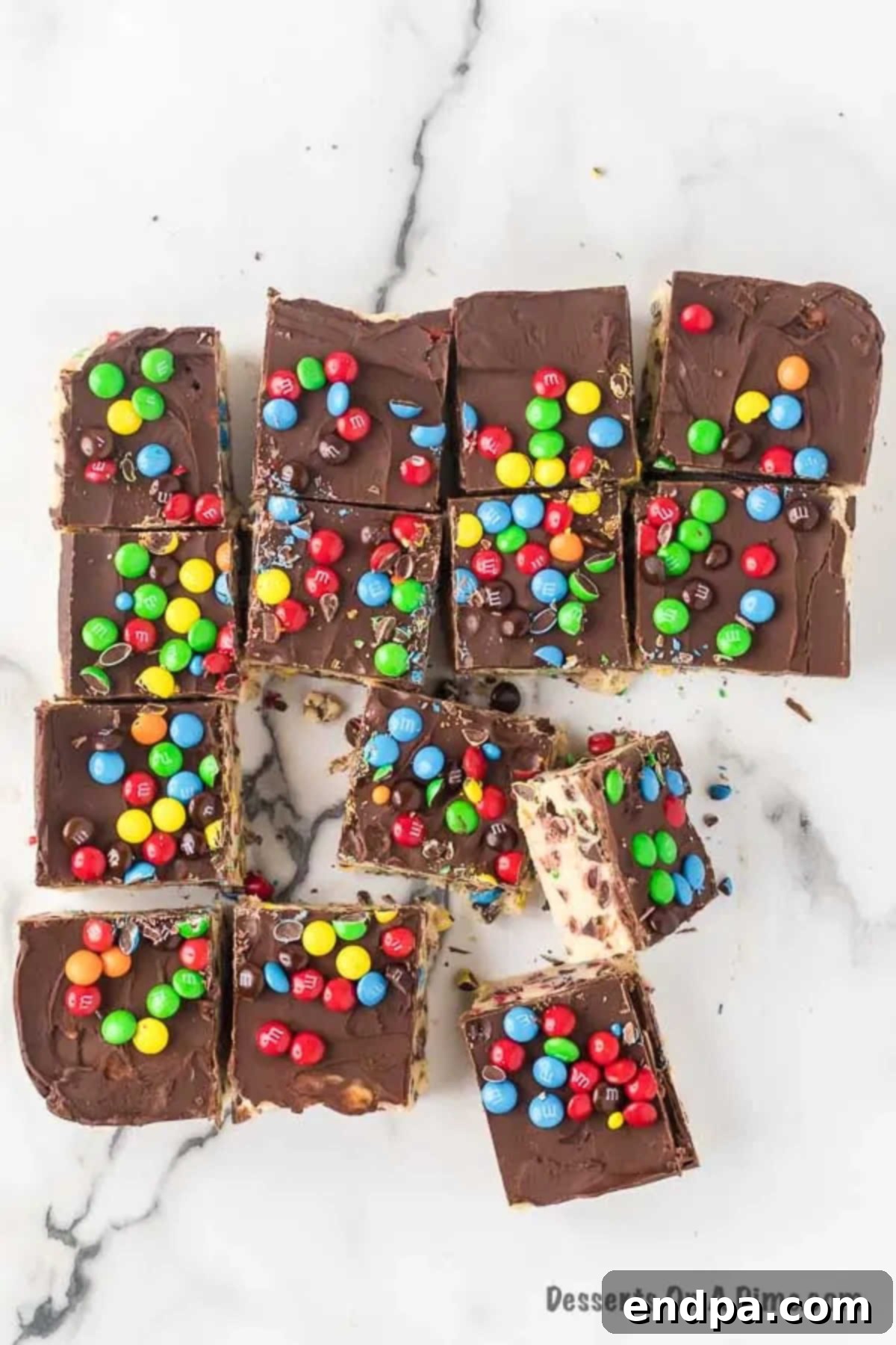 Close-up of freshly cut cookie dough bars, stacked in a serving dish.