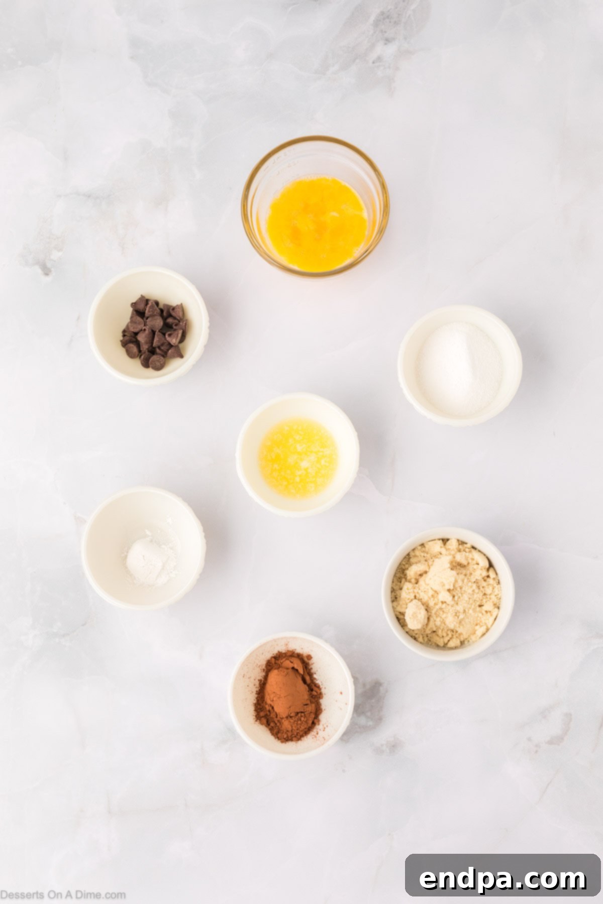 Ingredients for keto cake - butter, almond flour, swerve, cocoa powder, baking powder, egg, chocolate chips.