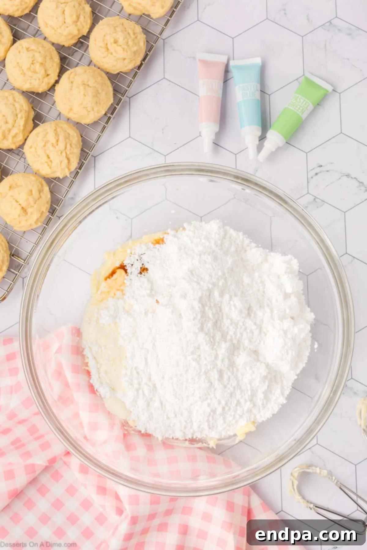 Cloud-Soft Sour Cream Cookies 12 Ingredients for buttercream frosting, including softened butter, powdered sugar, and heavy cream, combined in a mixing bowl.