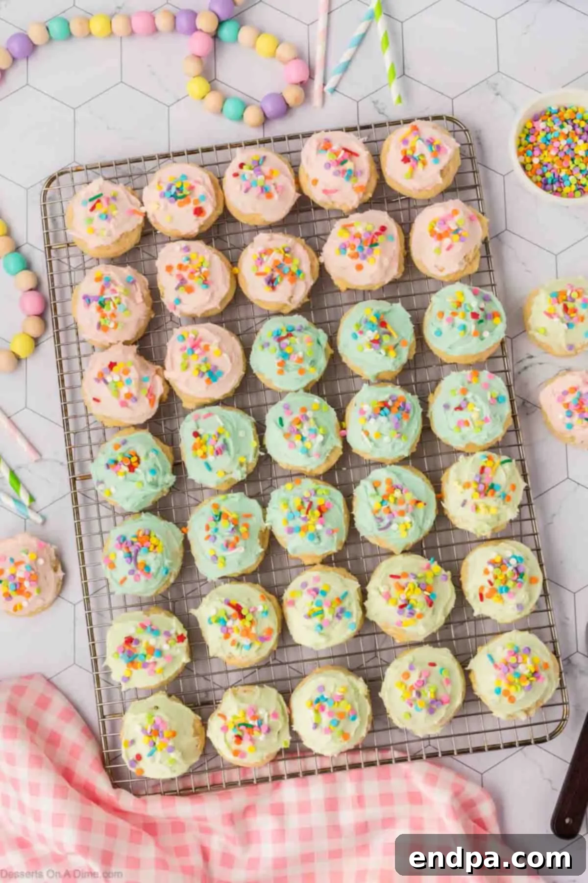 Cloud-Soft Sour Cream Cookies 14 Delightful Sour Cream Sugar Cookies, beautifully frosted and adorned with colorful sprinkles, ready to be served.