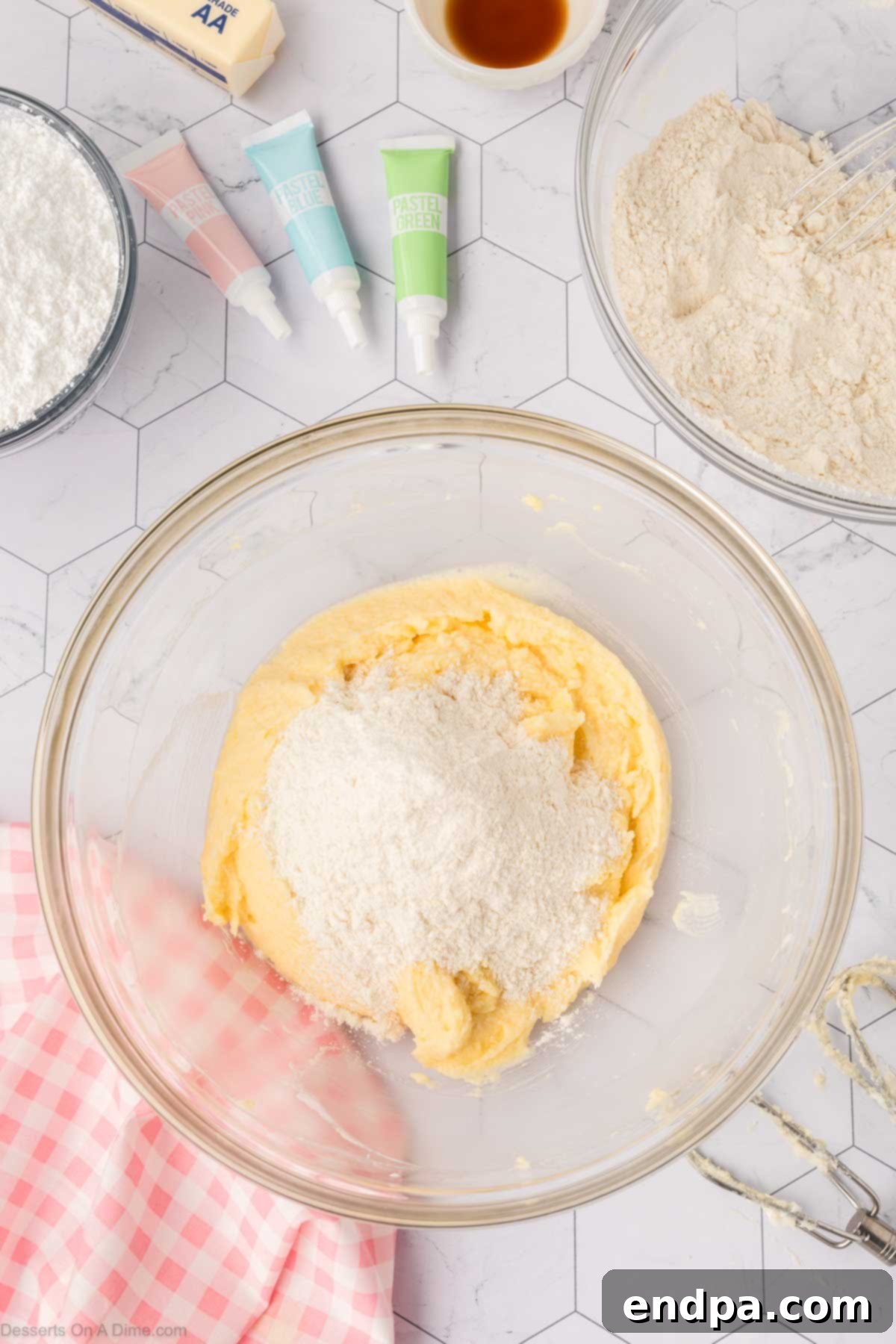 Cloud-Soft Sour Cream Cookies 8 Dry ingredients being gradually added to the wet cookie dough mixture in a large mixing bowl.