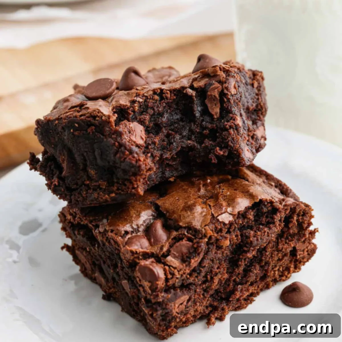 Close-up of a stack of fudgy, crinkly-top brownies