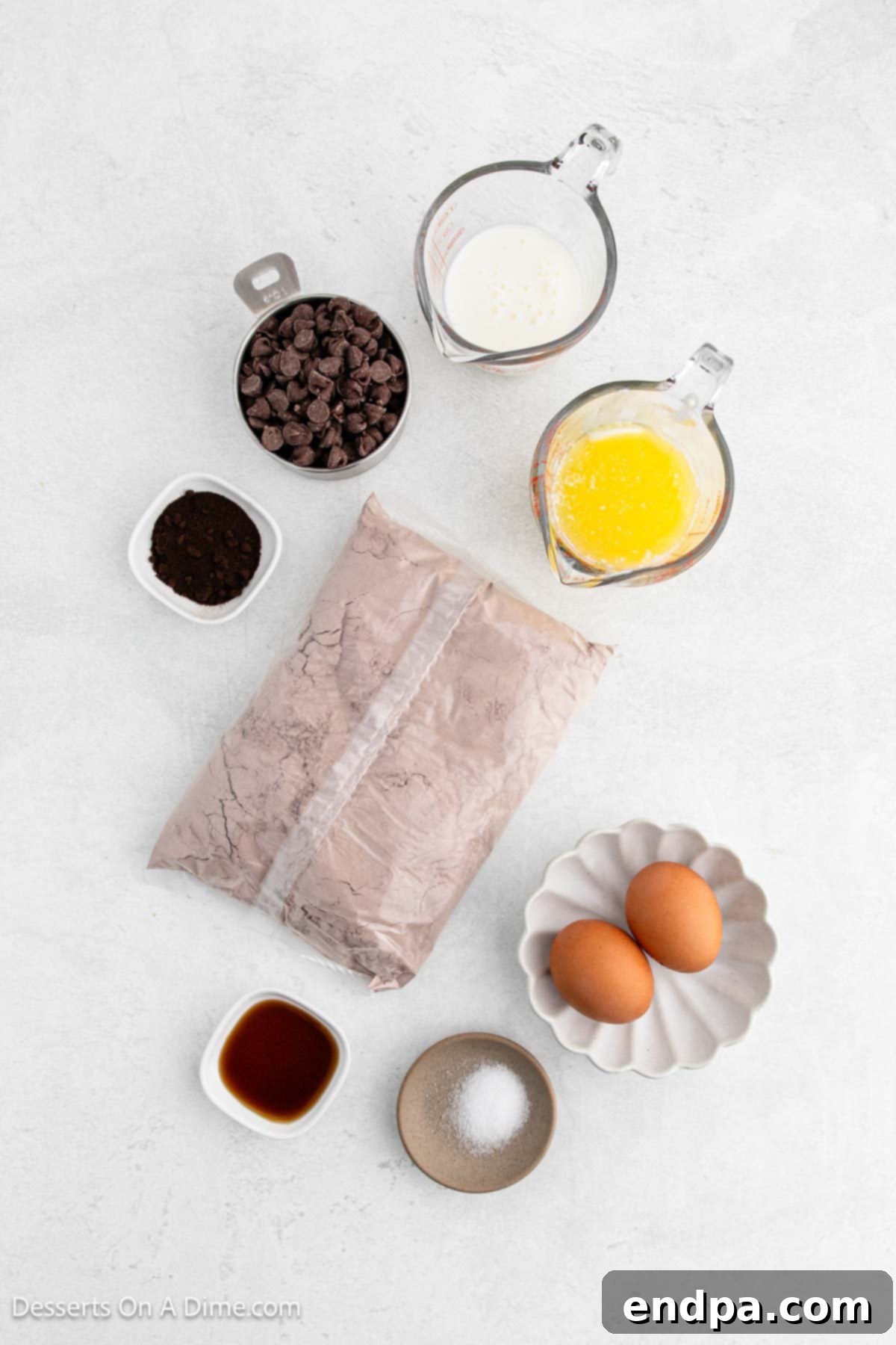 Ingredients laid out for enhanced box brownies: brownie mix, butter, buttermilk, eggs, coffee granules, vanilla extract, salt, and chocolate chips.