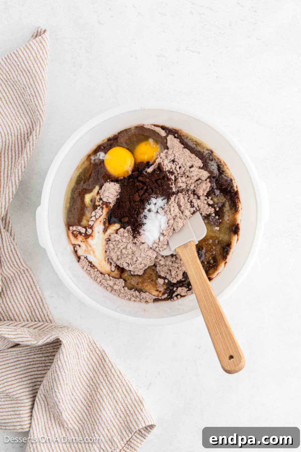 Large mixing bowl with box brownie mix, melted butter, buttermilk, eggs, instant coffee granules, vanilla extract, and salt combined.