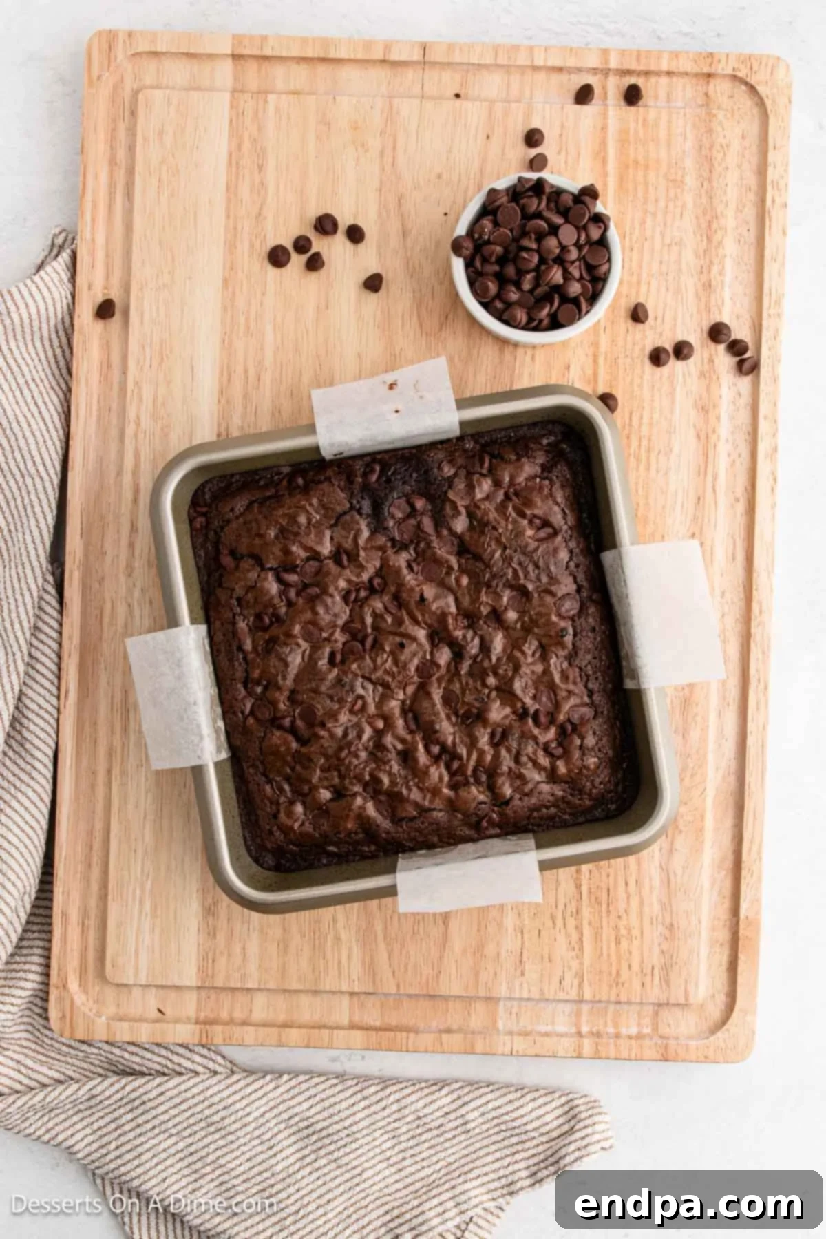 Freshly baked brownies cooling in the pan after being removed from the oven.