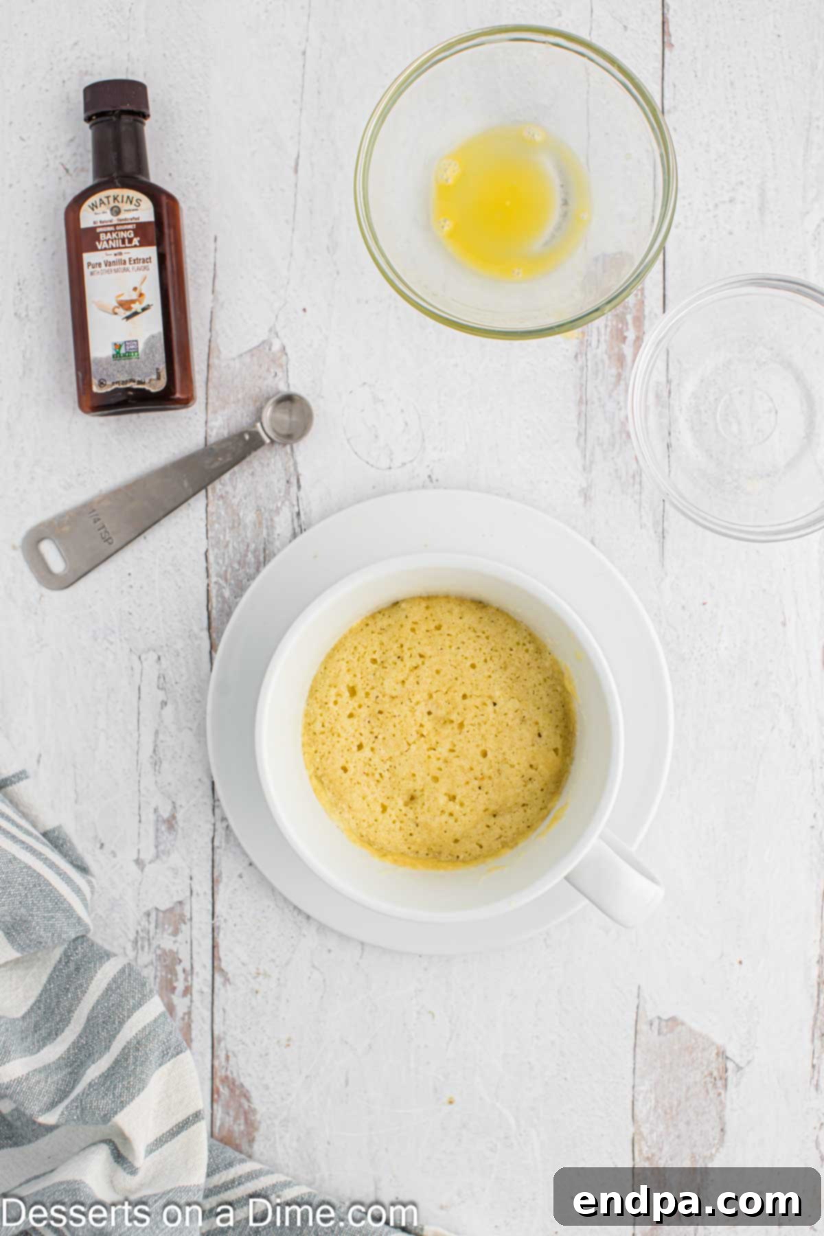 Vanilla Keto Mug Cake 4 Cooked mug cake removed from the microwave, golden brown and risen.