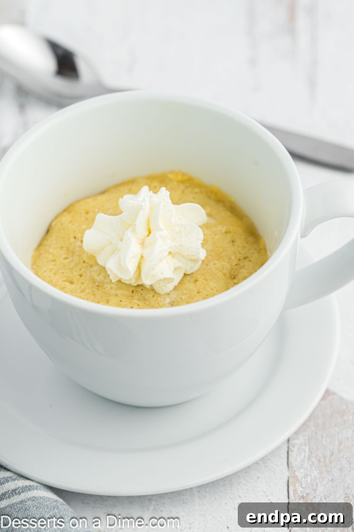 Vanilla Keto Mug Cake 5 Finished Keto Vanilla Mug Cake topped with a generous dollop of whipped cream.
