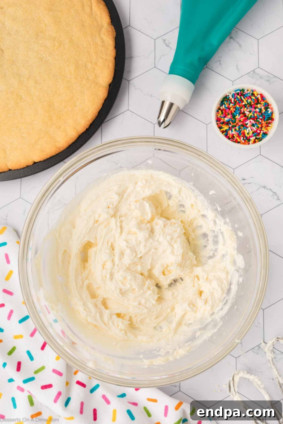 Heavy cream being slowly added to the developing buttercream frosting mixture, to achieve the perfect consistency.