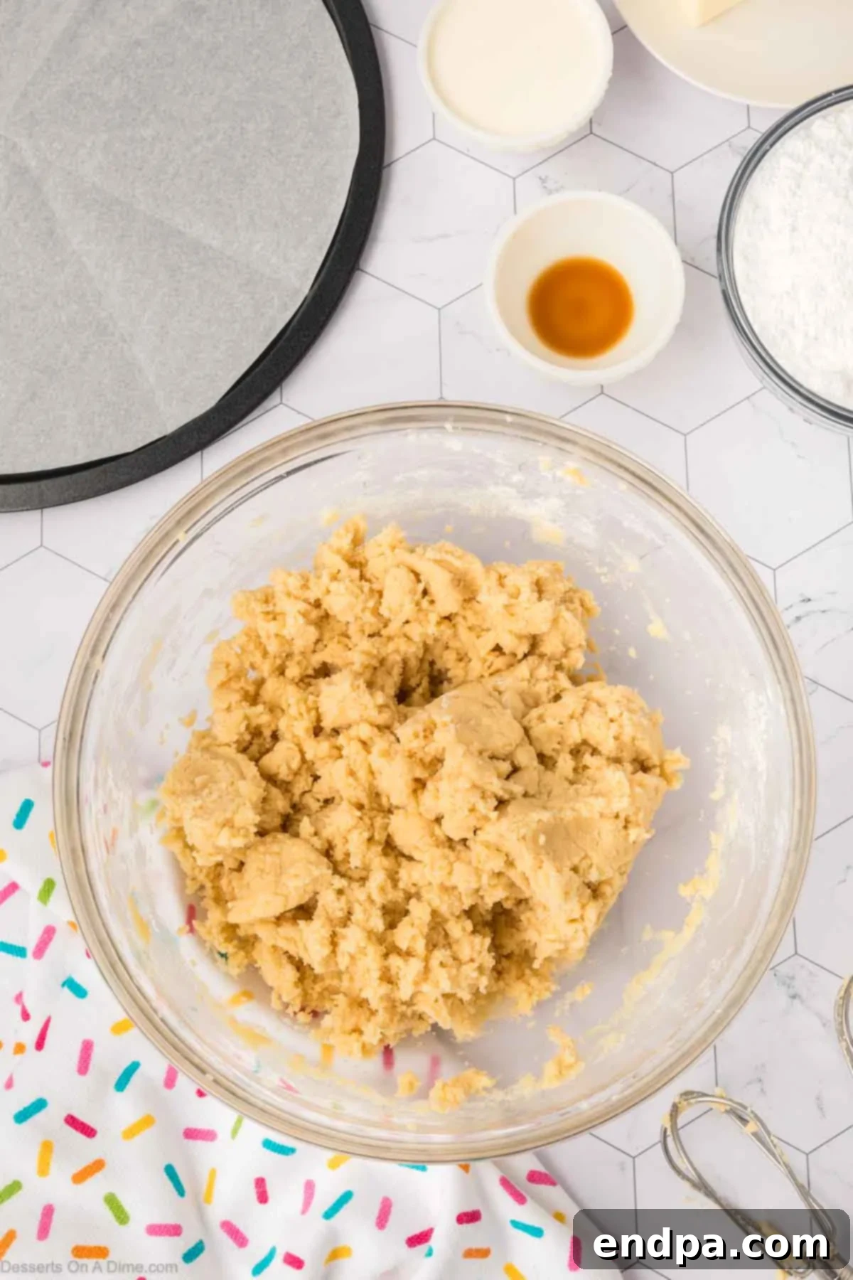 The sugar cookie dough, perfectly mixed and ready to be pressed into the prepared cake pan.