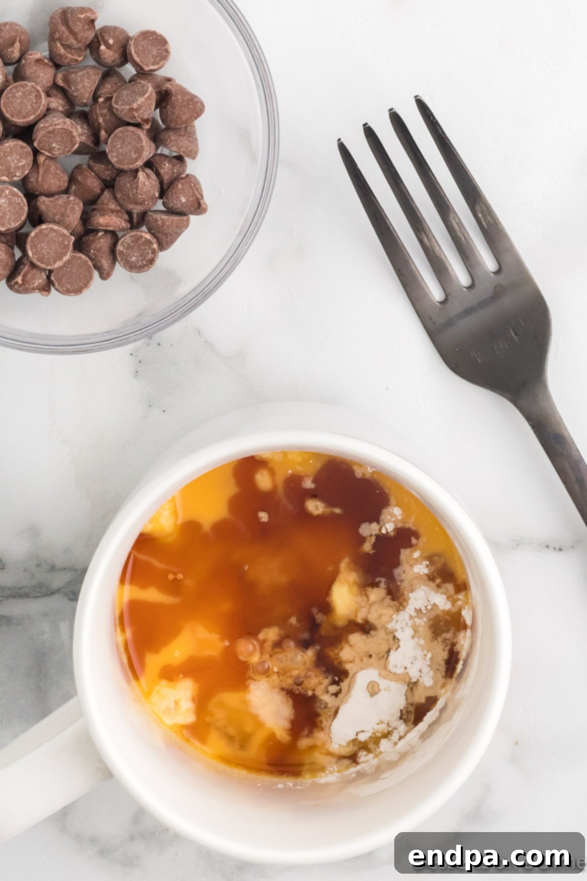 Heavenly Keto Chocolate Chip Mug Cake 4 Mug with all dry and wet ingredients combined, except chocolate chips.