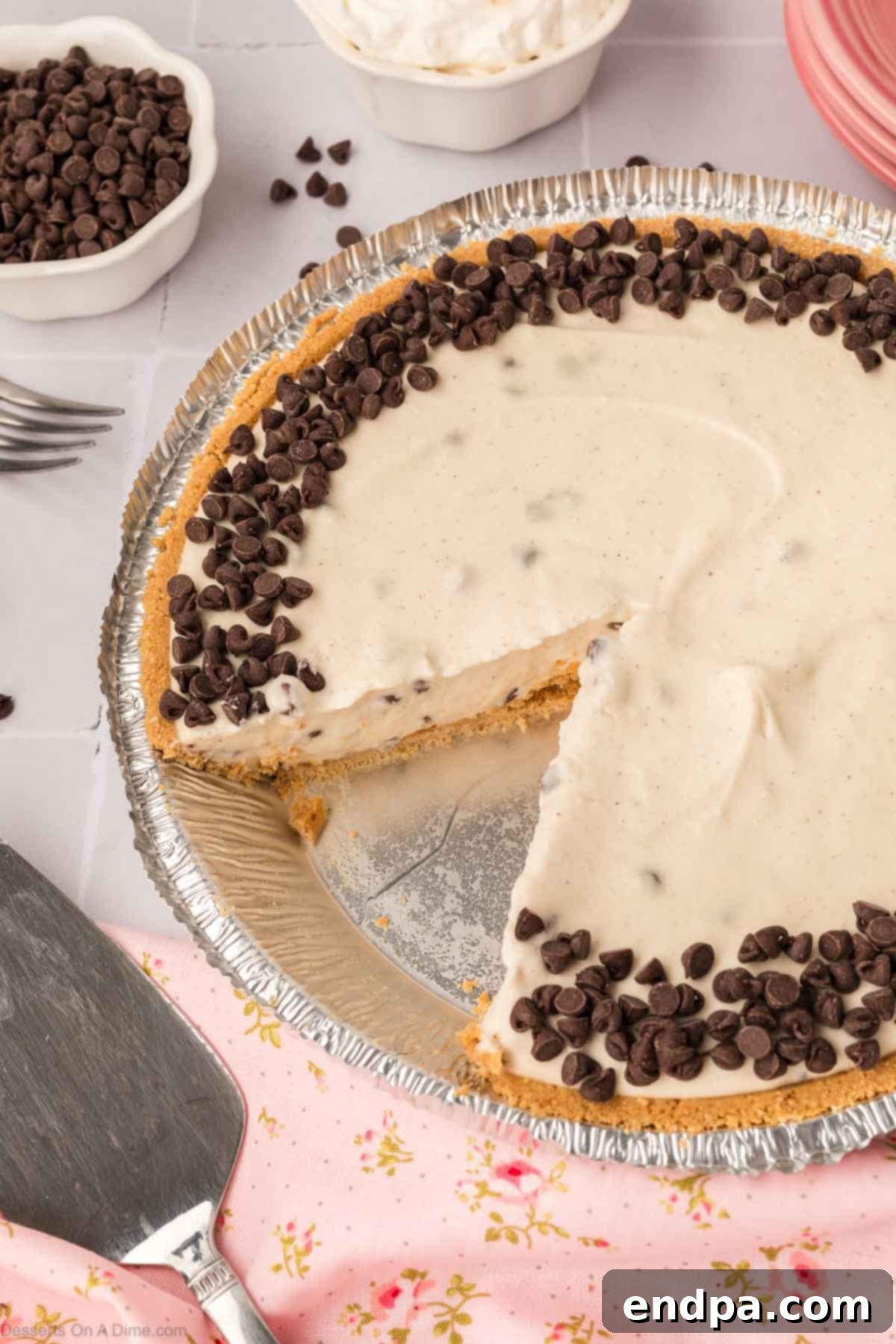 A beautifully sliced Cannoli Pie, showcasing its creamy filling, chocolate chips, and golden graham cracker crust, ready to be served.