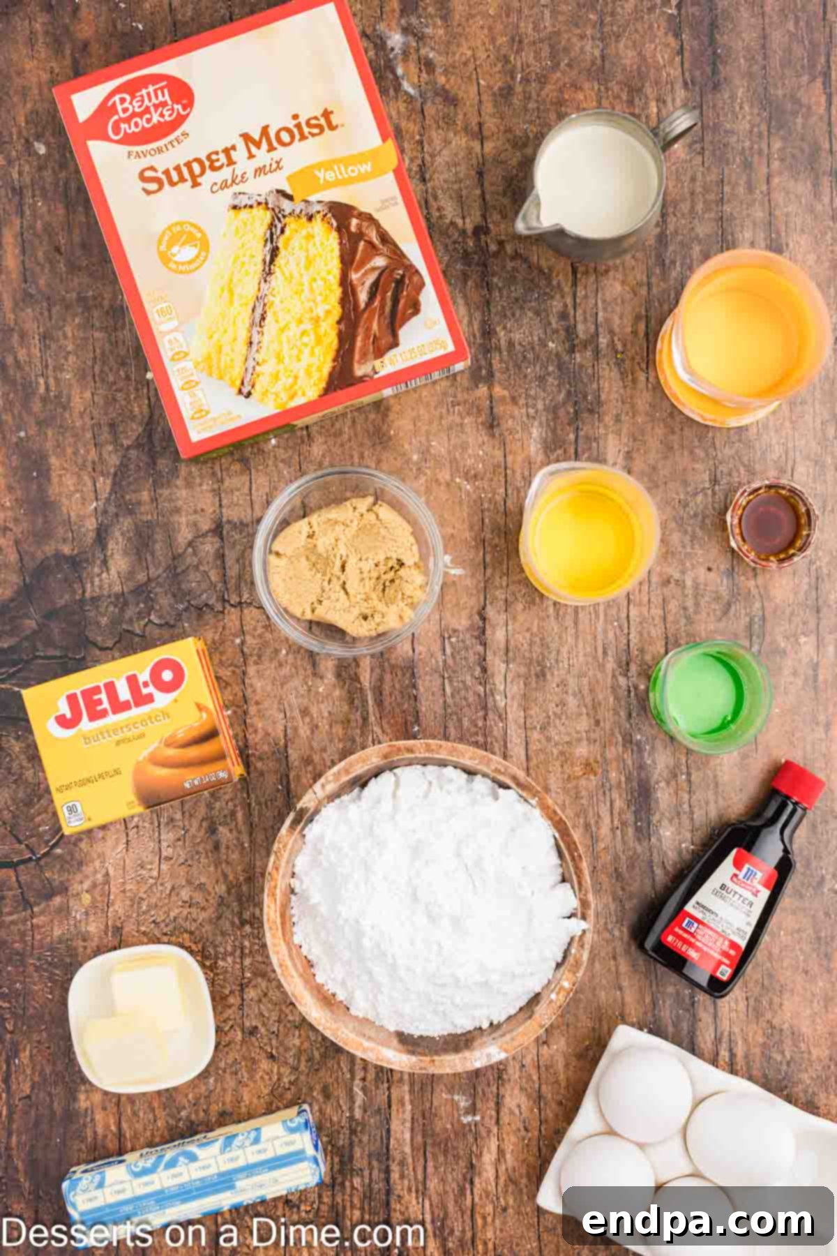 A collection of ingredients for Harry Potter Butterbeer Cupcakes, including yellow cake mix, butterscotch instant pudding, eggs, vegetable oil, heavy cream, brown sugar, corn syrup, butter, vanilla extract, salt, and powdered sugar, neatly arranged for baking.